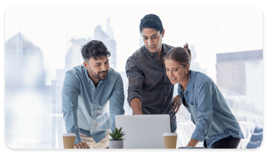 Three people looking at a laptop together