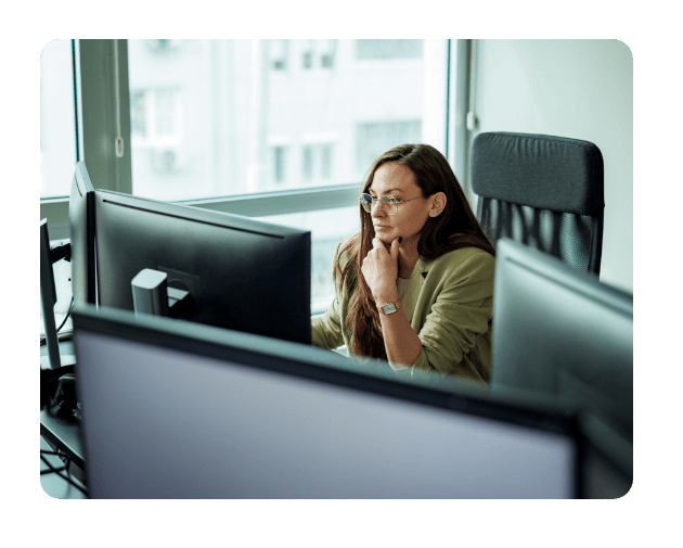 a woman wearing glasses working in the office