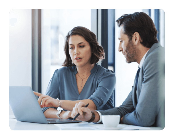 two people working on a laptop at the office together