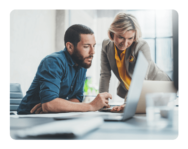 two people working on a laptop at the office together