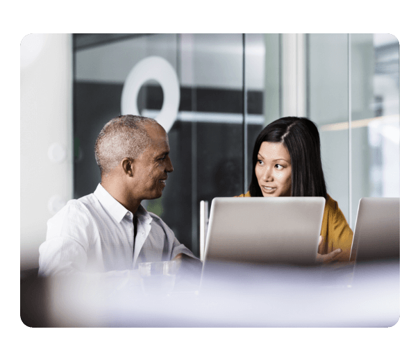 a woman and a man talking together at the office