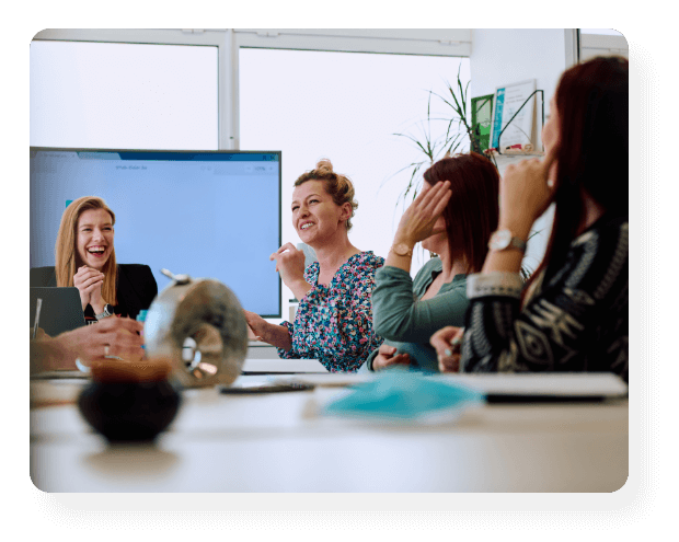 people talking and laughing at a meeting