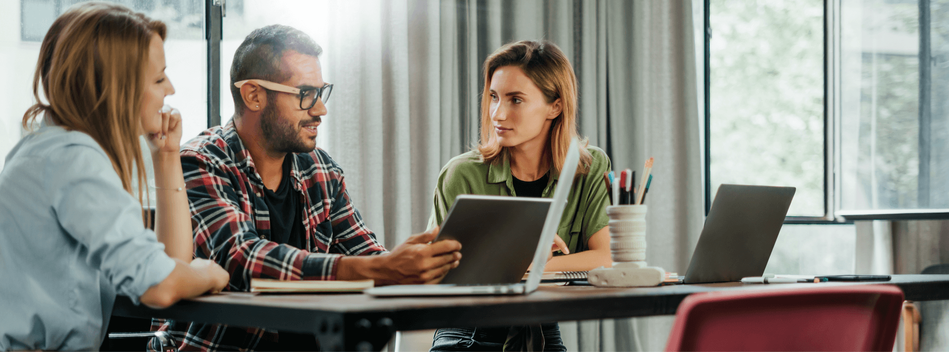 Group of marketers sitting around a computer talking